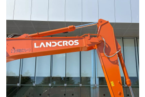 Rebranded LANDCROS excavator boom arm outside Hitachi headquarters