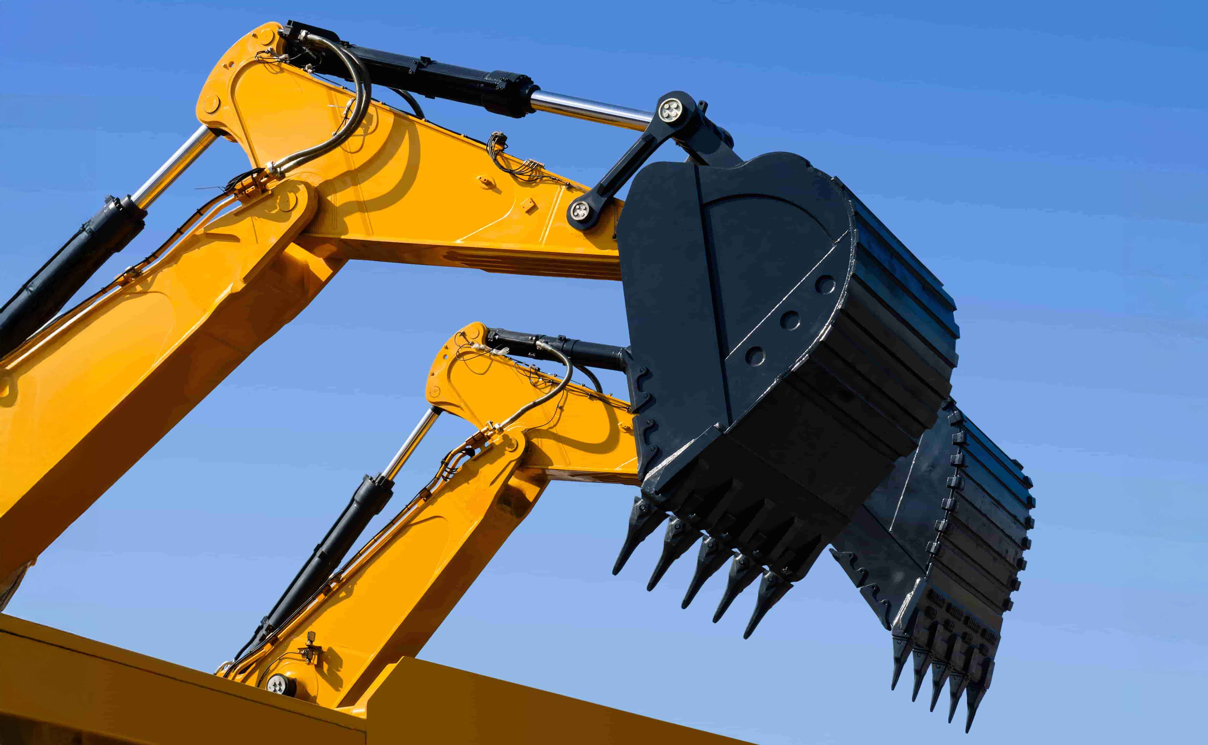 excavator arm with buckets featuring tiger tooth attachments