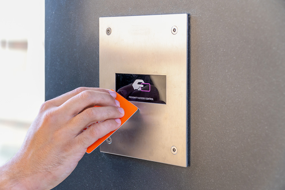 Image of a hand utilizing a contactless entry scanner