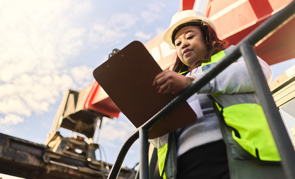 Woman with clipboard documenting on a construction jobsite