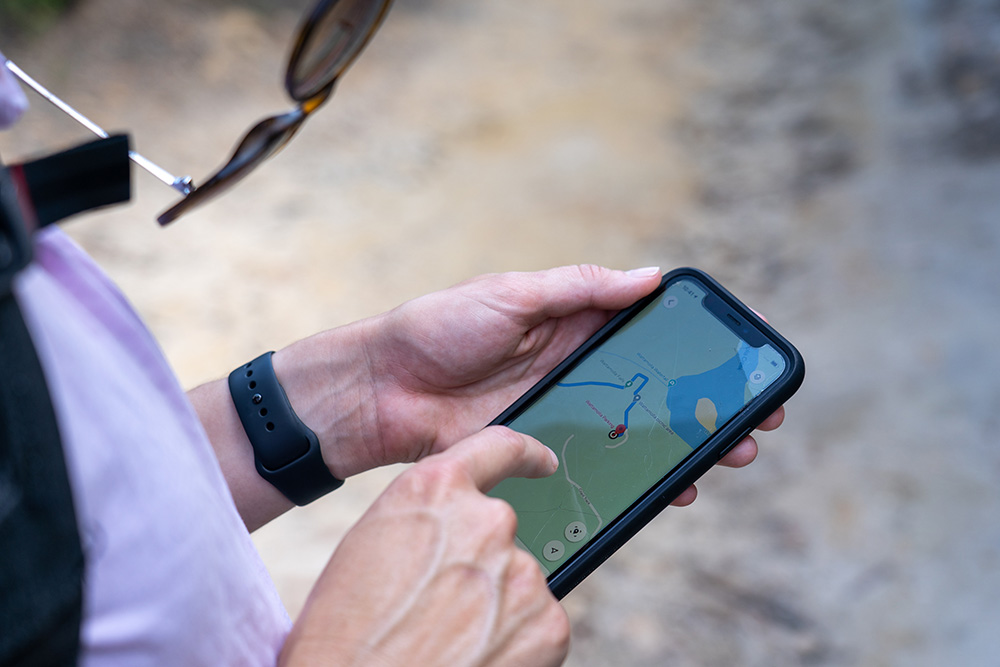 Woman looking at navigation tracker on phone