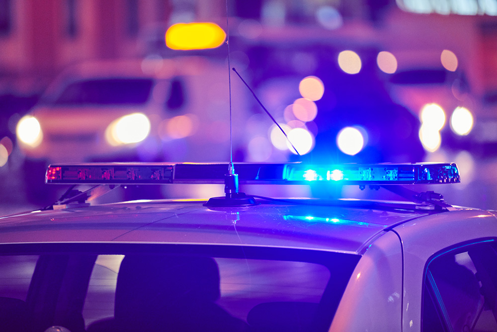 Police vehicle with flashing lights at night
