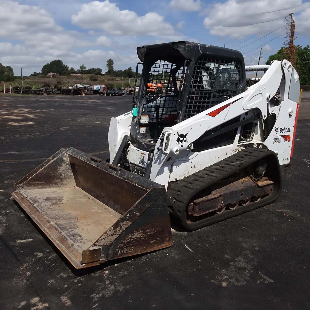 Bobcat CTL machine sitting idle in parking lot