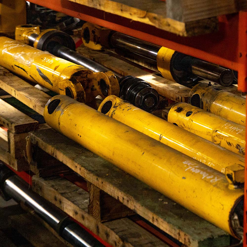 Multiple hydraulic cylinders sits on shelves